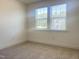 Bright bedroom with neutral carpet, double electric outlet, and natural light from one window at 63 Tee Time Ter, Benson, NC 27504