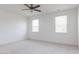 Bright bedroom with carpet flooring, neutral walls, a ceiling fan, and two windows at 63 Tee Time Ter, Benson, NC 27504