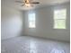 Light-filled, unfinished bedroom with a ceiling fan and views from two windows at 63 Tee Time Ter, Benson, NC 27504