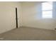 Cozy bedroom with plush carpeting, a window for natural light, and a spacious closet at 63 Tee Time Ter, Benson, NC 27504