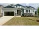 Charming craftsman-style home with a two-car garage, stone accents, and a well-manicured lawn at 63 Tee Time Ter, Benson, NC 27504