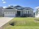 Charming single-Gathering home featuring a two-car garage and lush lawn at 63 Tee Time Ter, Benson, NC 27504