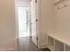 Open hallway with hardwood floors, coat hooks and convenient bench seating at 63 Tee Time Ter, Benson, NC 27504