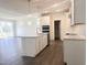 Modern kitchen island with white cabinets, stone countertop, sink, and stainless steel faucet at 63 Tee Time Ter, Benson, NC 27504