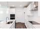 Bright kitchen features white cabinets, a large island, stainless steel appliances, and hardwood floors at 63 Tee Time Ter, Benson, NC 27504