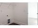 Neat laundry room with shelving, wood-look flooring, and access to another closet at 63 Tee Time Ter, Benson, NC 27504