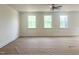 Bright and airy living room features three large windows and a ceiling fan at 63 Tee Time Ter, Benson, NC 27504