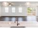 Open concept living room with hardwood floors, ample natural light, and view to the kitchen at 63 Tee Time Ter, Benson, NC 27504
