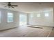 Spacious living room with ample natural light and sliding glass doors leading to an outdoor screened in patio at 63 Tee Time Ter, Benson, NC 27504