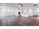Open-concept floor plan featuring a modern kitchen with hardwood floors flowing into the living area at 63 Tee Time Ter, Benson, NC 27504