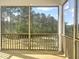 Relaxing screened porch offering views of the natural landscape and blue sky at 63 Tee Time Ter, Benson, NC 27504