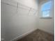 Small walk-in closet space featuring carpeted flooring, wire shelving, and a single window at 63 Tee Time Ter, Benson, NC 27504