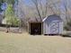 Backyard features a shed with space to store a lawnmower and a porch swing at 703 E Stanley St, Four Oaks, NC 27524