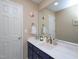 Bathroom featuring a large mirror, blue cabinets, and coastal-themed decorations at 703 E Stanley St, Four Oaks, NC 27524