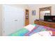 Cozy bedroom featuring a colorful bedspread, closet and wood dresser at 703 E Stanley St, Four Oaks, NC 27524