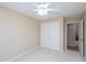 Beige-toned bedroom with a double door closet and an adjoining room at 703 E Stanley St, Four Oaks, NC 27524