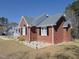 Well-built brick home featuring a side entrance, manicured lawn, and charming curb appeal with classic design at 703 E Stanley St, Four Oaks, NC 27524
