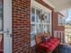 Inviting front porch with comfortable bench seating and decorative accents, perfect for enjoying a relaxing afternoon at 703 E Stanley St, Four Oaks, NC 27524