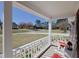 Charming front porch featuring white railings and rocking chairs, providing a relaxing outdoor space at 703 E Stanley St, Four Oaks, NC 27524