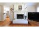 Living room with a white fireplace and hardwood floors at 703 E Stanley St, Four Oaks, NC 27524