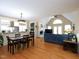 Open-concept living room features a fireplace, vaulted ceiling, and hardwood floors at 703 E Stanley St, Four Oaks, NC 27524