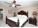 Comfortable bedroom features a ceiling fan, shuttered windows, and decorative furnishings at 703 E Stanley St, Four Oaks, NC 27524