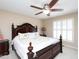 Spacious main bedroom featuring a ceiling fan, shuttered windows, and decorative furnishings at 703 E Stanley St, Four Oaks, NC 27524