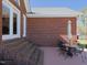 Cozy brick patio featuring an outdoor table and chairs, offering a tranquil space for outdoor dining or lounging at 703 E Stanley St, Four Oaks, NC 27524