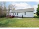 The backyard features a deck, patio, and a spacious lawn, perfect for outdoor activities at 7329 Blannie Farms, Willow Springs, NC 27592