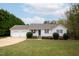 Charming one-story home with a two-car garage and well-manicured lawn at 7329 Blannie Farms, Willow Springs, NC 27592