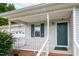 Close-up of front porch with storm door and view of attached garage at 7329 Blannie Farms, Willow Springs, NC 27592