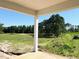 A covered porch with view of a spacious backyard and tree line, ideal for outdoor living and entertaining at 79 Tee Time Ter, Benson, NC 27504