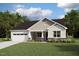 Charming single-Gathering home with a two-car garage, lush lawn, and beautiful landscaping, creating great curb appeal at 84 Tee Time Ter, Benson, NC 27504