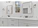 Bathroom with marble countertop, double vanity, framed mirrors, and modern fixtures at 8487 Old Us 421, Lillington, NC 27546
