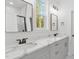 Bathroom with double vanity, marble countertop, framed mirrors, and walk-in shower at 8487 Old Us 421, Lillington, NC 27546