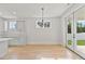 Dining area showcasing tile backsplash, modern lighting, and a sliding glass door at 8487 Old Us 421, Lillington, NC 27546