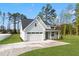 Exterior showcasing a two-car garage, fresh landscaping, and a paved driveway at 8487 Old Us 421, Lillington, NC 27546