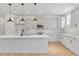 Bright kitchen featuring an island with marble counters, stainless appliances, and modern lighting at 8487 Old Us 421, Lillington, NC 27546
