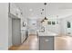Modern kitchen features marble counters, an island, stainless appliances, and stylish lighting at 8487 Old Us 421, Lillington, NC 27546