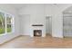Bright living room features a fireplace, wood floors, and natural light from windows at 8487 Old Us 421, Lillington, NC 27546