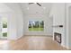 Living room boasts a fireplace, hardwood floors, and a large window offering a great view at 8487 Old Us 421, Lillington, NC 27546