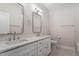 A sleek bathroom features a double sink vanity, mirrors, and modern fixtures at 934 Woodland Rd, Creedmoor, NC 27522