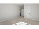 A bright bedroom features neutral walls and carpet, plus two white doors at 934 Woodland Rd, Creedmoor, NC 27522