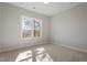 Bright bedroom features a window with scenic views and neutral carpet at 934 Woodland Rd, Creedmoor, NC 27522