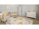 Adorable Bedroom with a crib, dresser, comfortable chair, and playful animal-themed rug at 934 Woodland Rd, Creedmoor, NC 27522