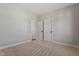 A bright bedroom with neutral carpet and two white doors at 934 Woodland Rd, Creedmoor, NC 27522