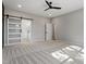 A bright bedroom features a sliding glass door to the ensuite bathroom and a ceiling fan at 934 Woodland Rd, Creedmoor, NC 27522