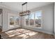 Bright dining room featuring an elegant chandelier, access to the back porch, and large windows with great views at 934 Woodland Rd, Creedmoor, NC 27522
