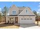 Charming two-story home featuring a 2-car garage, landscaped yard, and craftsman details at 934 Woodland Rd, Creedmoor, NC 27522