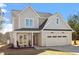 Charming home with neutral siding, an attached garage, and a welcoming porch at 934 Woodland Rd, Creedmoor, NC 27522